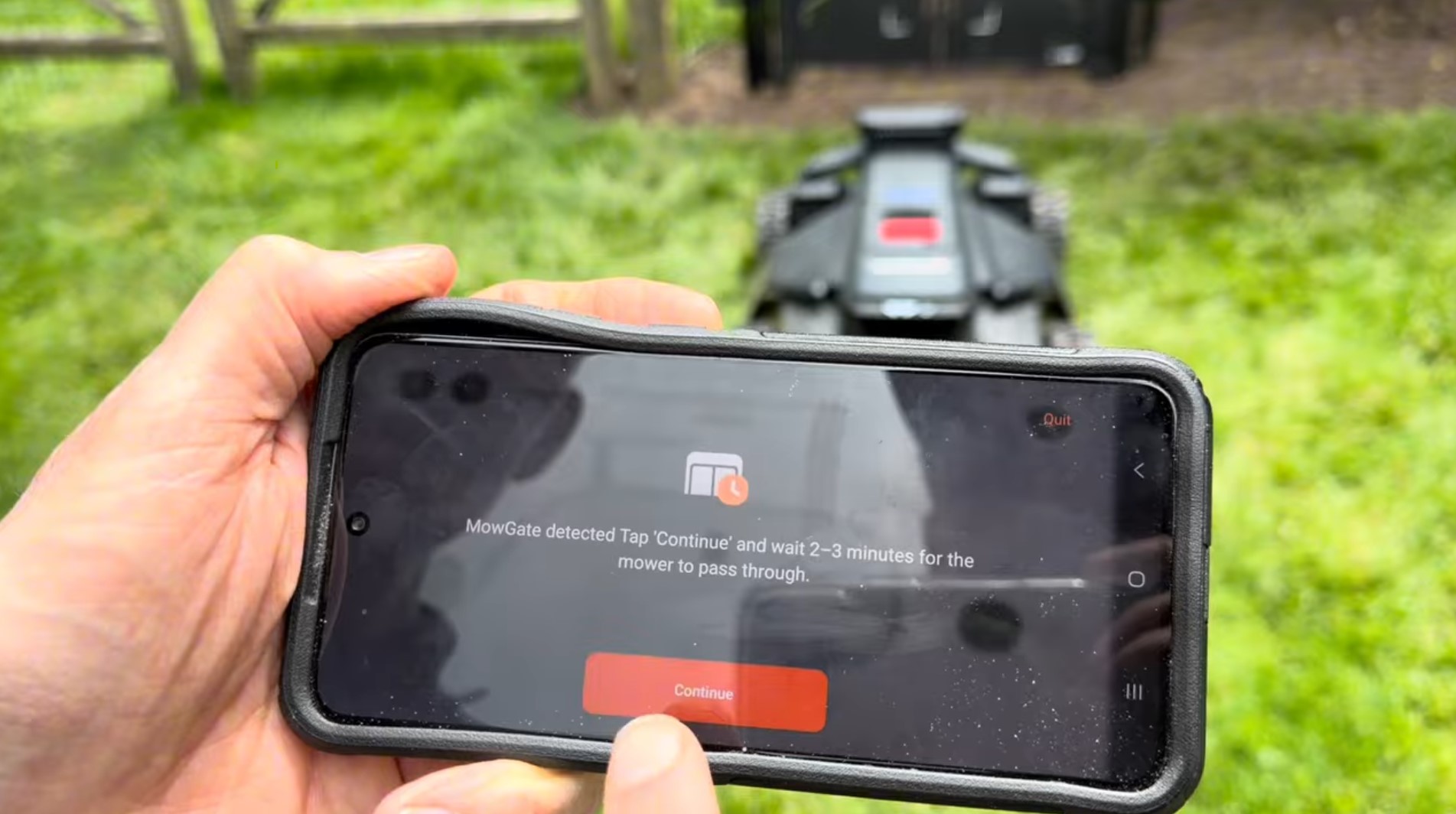 The Navimow app showing the MowGate detected prompt with a Continue button while the mower waits at the gate