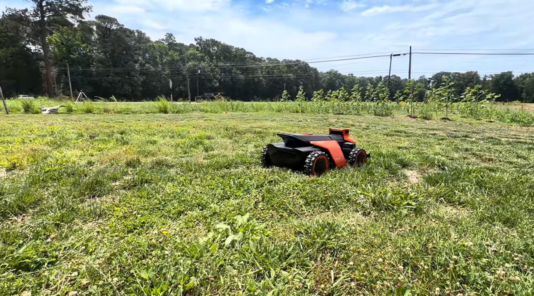 The Terranox working through an overgrown field with tall weeds and uneven ground