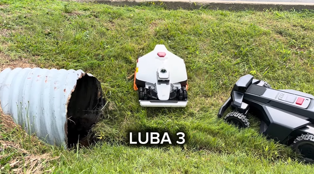 The Mammotion LUBA 3 and Segway Navimow X430 crossing a rutted, ditched grassy slope