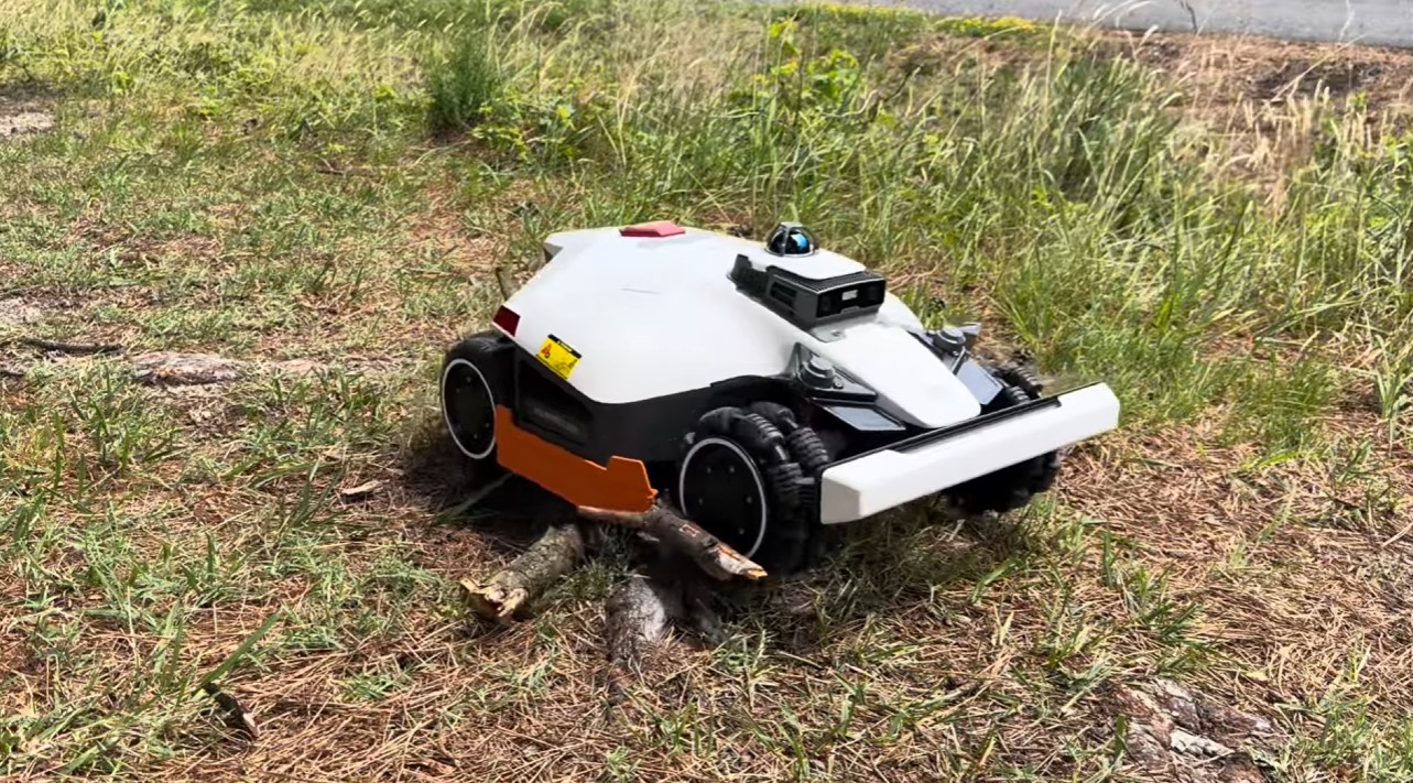 A Mammotion LUBA 3 with 360-degree LiDAR crossing rough, uneven ground