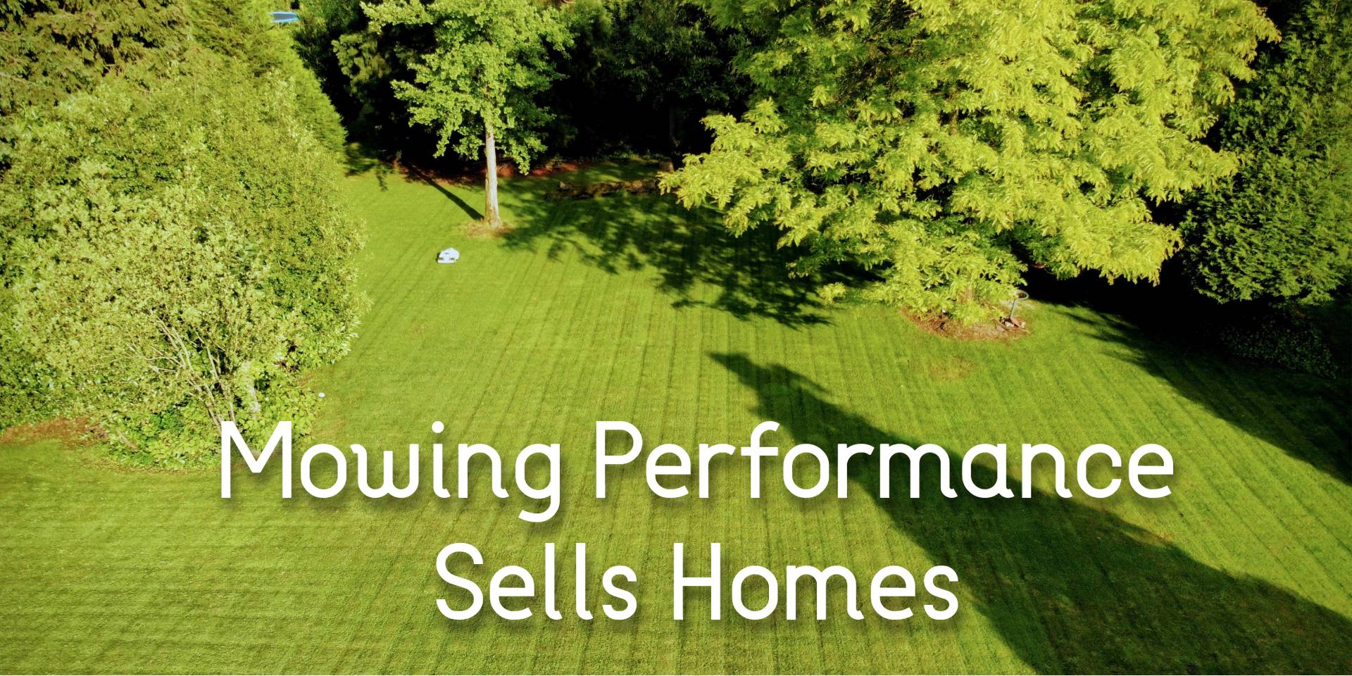 Aerial view of a freshly striped lawn kept perfectly cut by a robot mower — mowing performance that sells homes